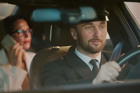 Professional chauffeur driving a premium vehicle